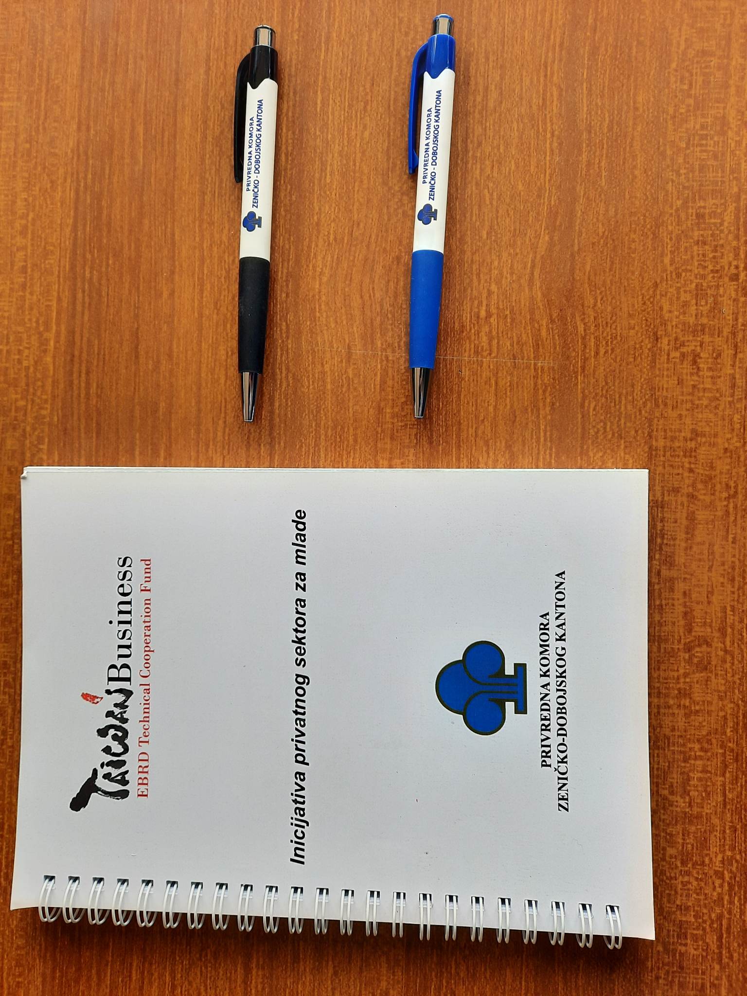 notepads and pens with the logo